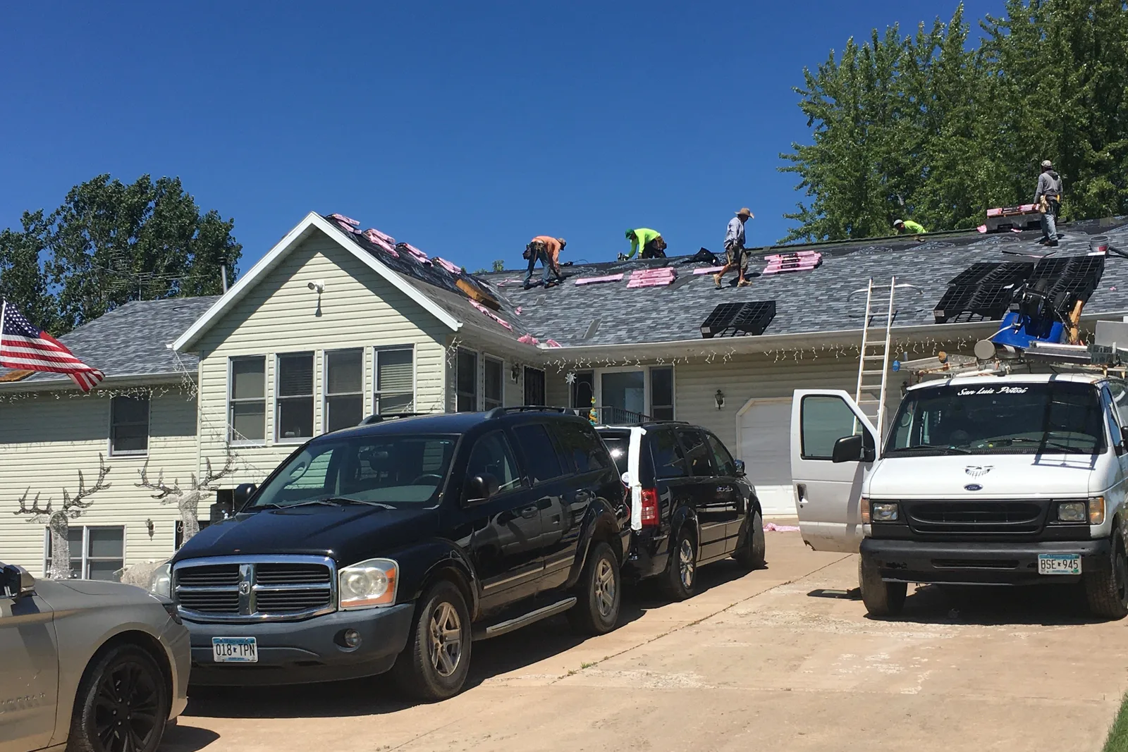 Roofing crew working on a home