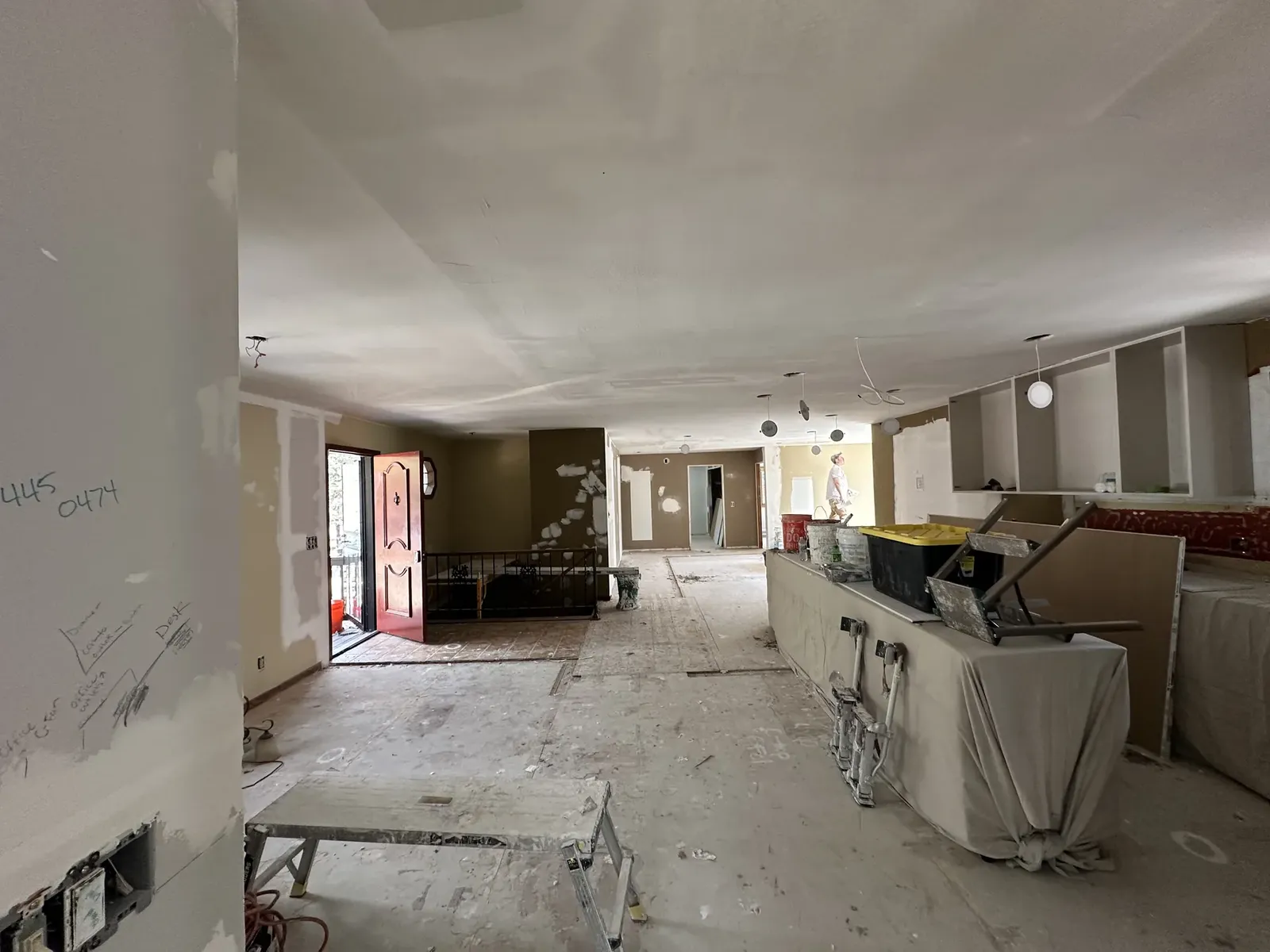Open interior remodel area with unfinished surfaces and protected cabinetry