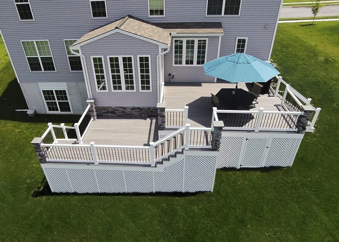 Aerial view of a composite deck with white railing and stairs
