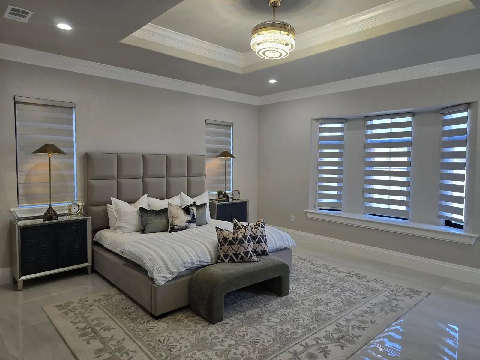 Bedroom with tray ceiling and modern window shades