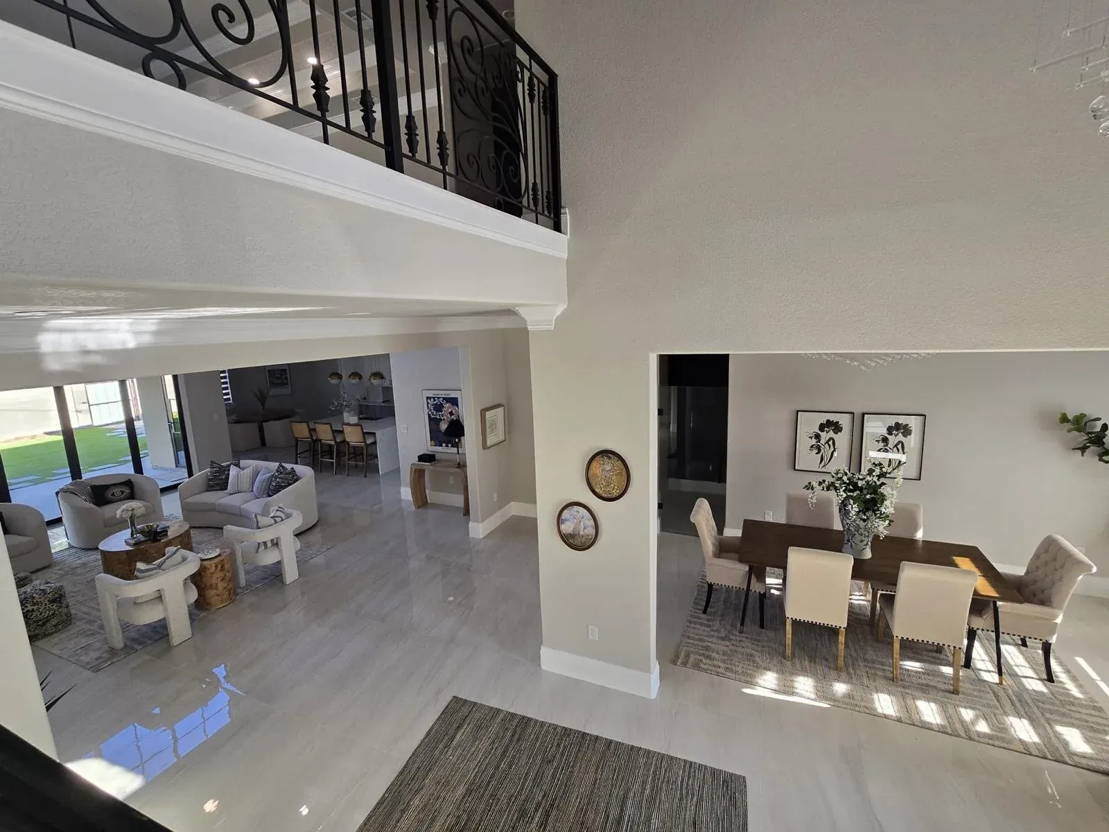 Open-plan living and dining interior with a double-height ceiling