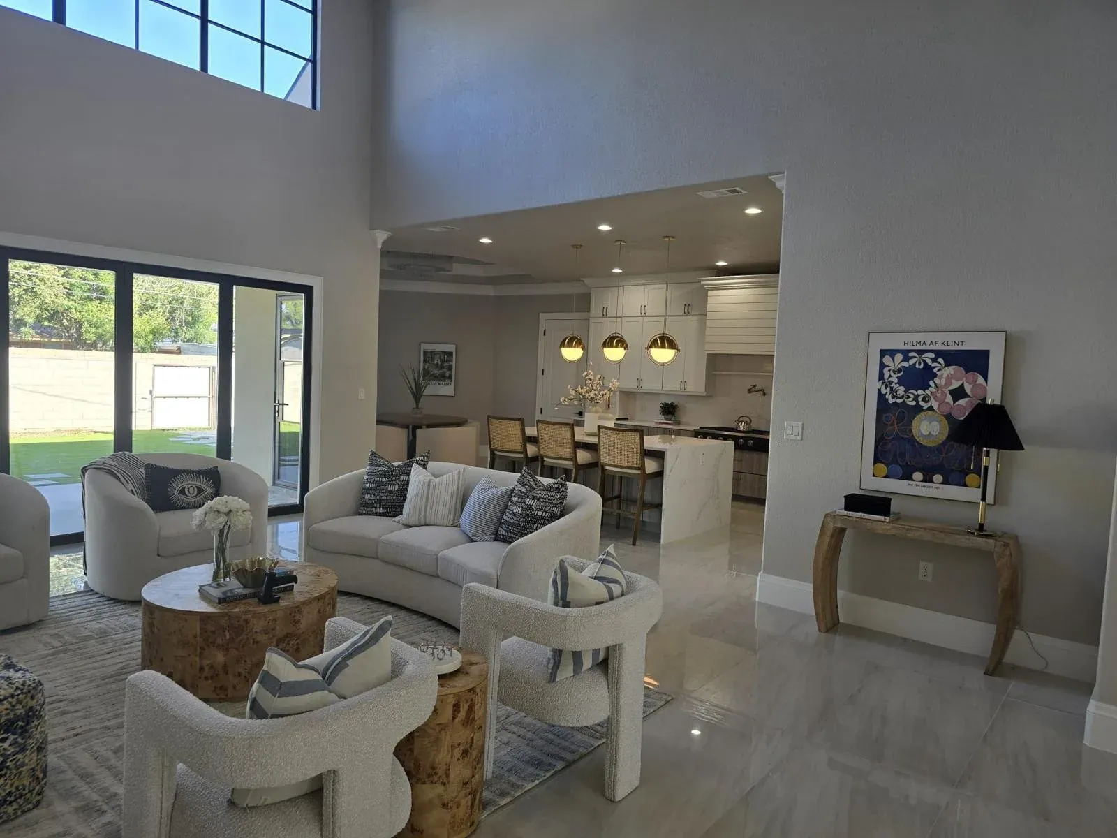 Open-plan living area and kitchen with light tile flooring