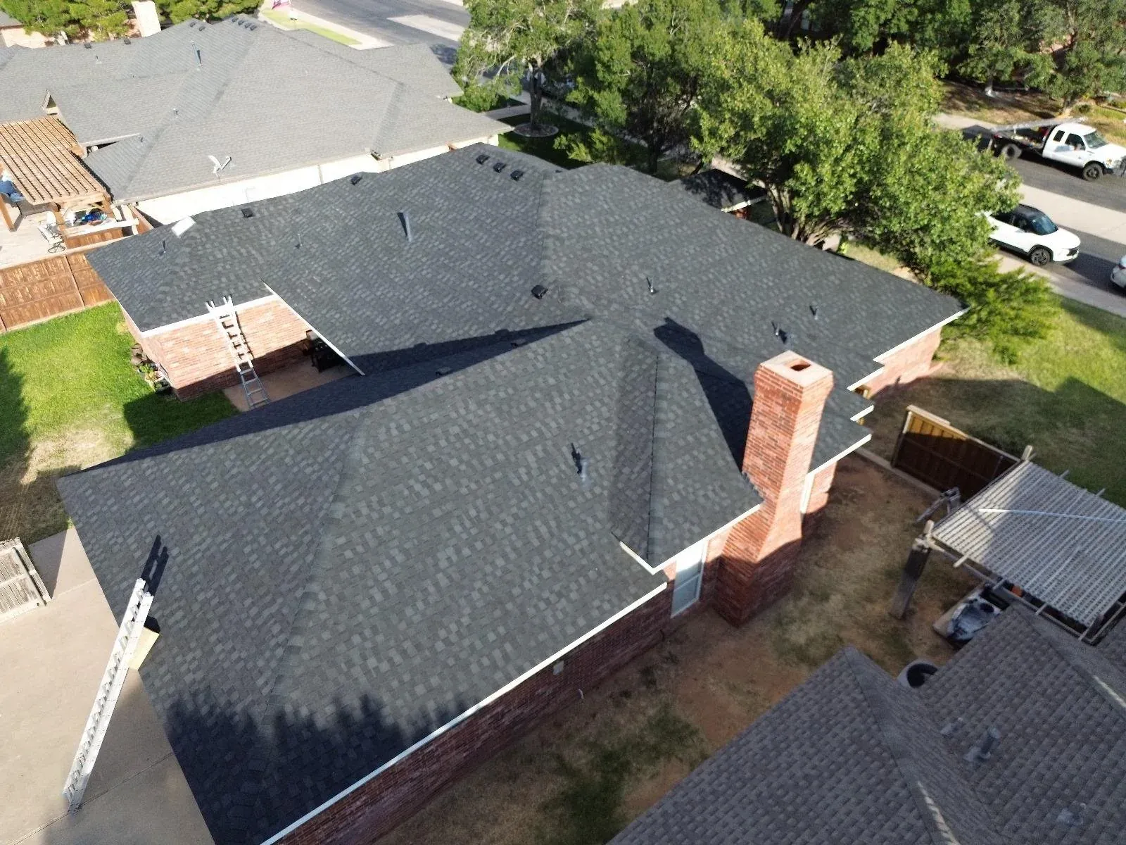 Aerial view across a dark asphalt-shingle roof