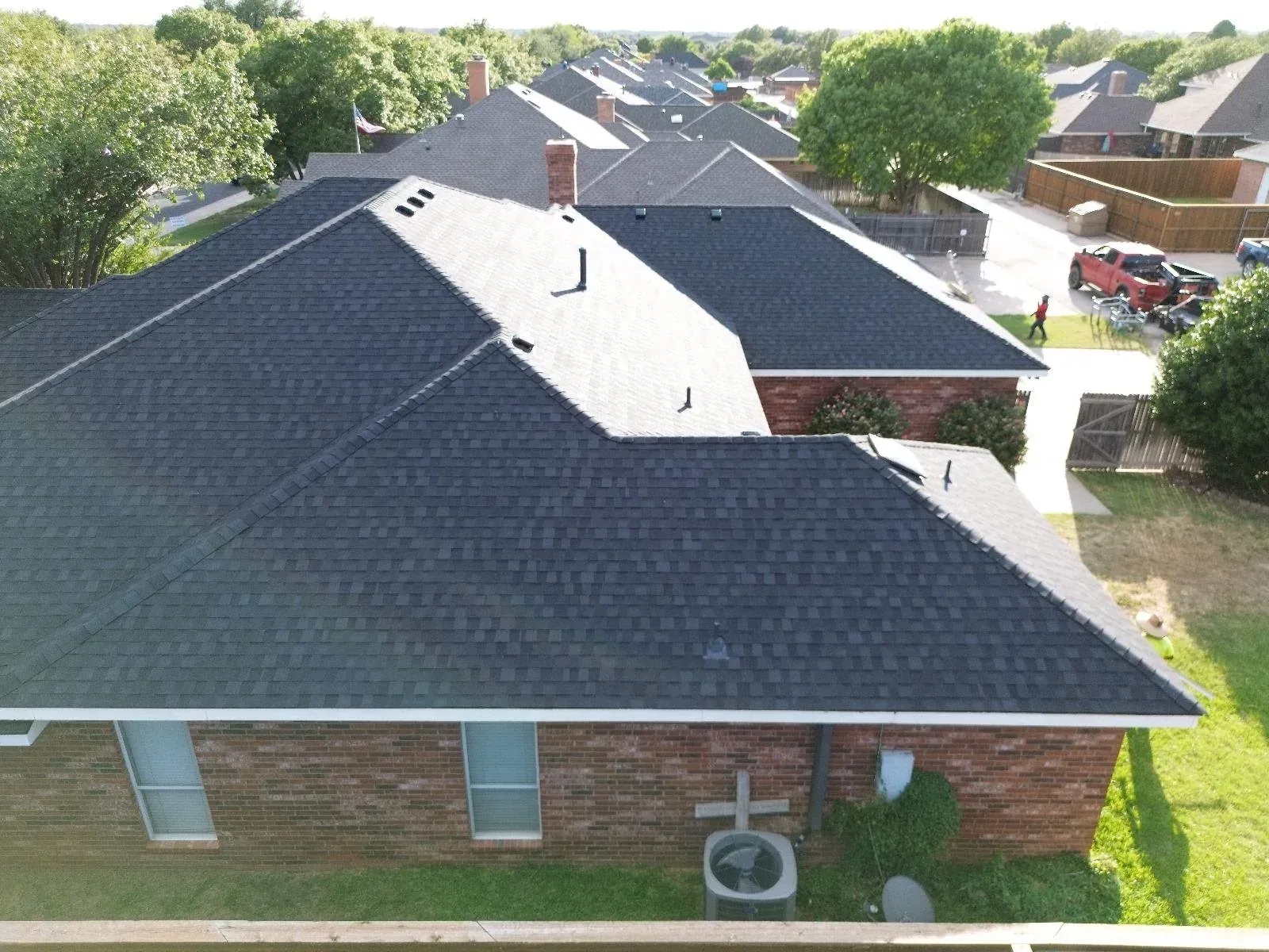 Aerial view of a dark asphalt-shingle roof and ridge lines