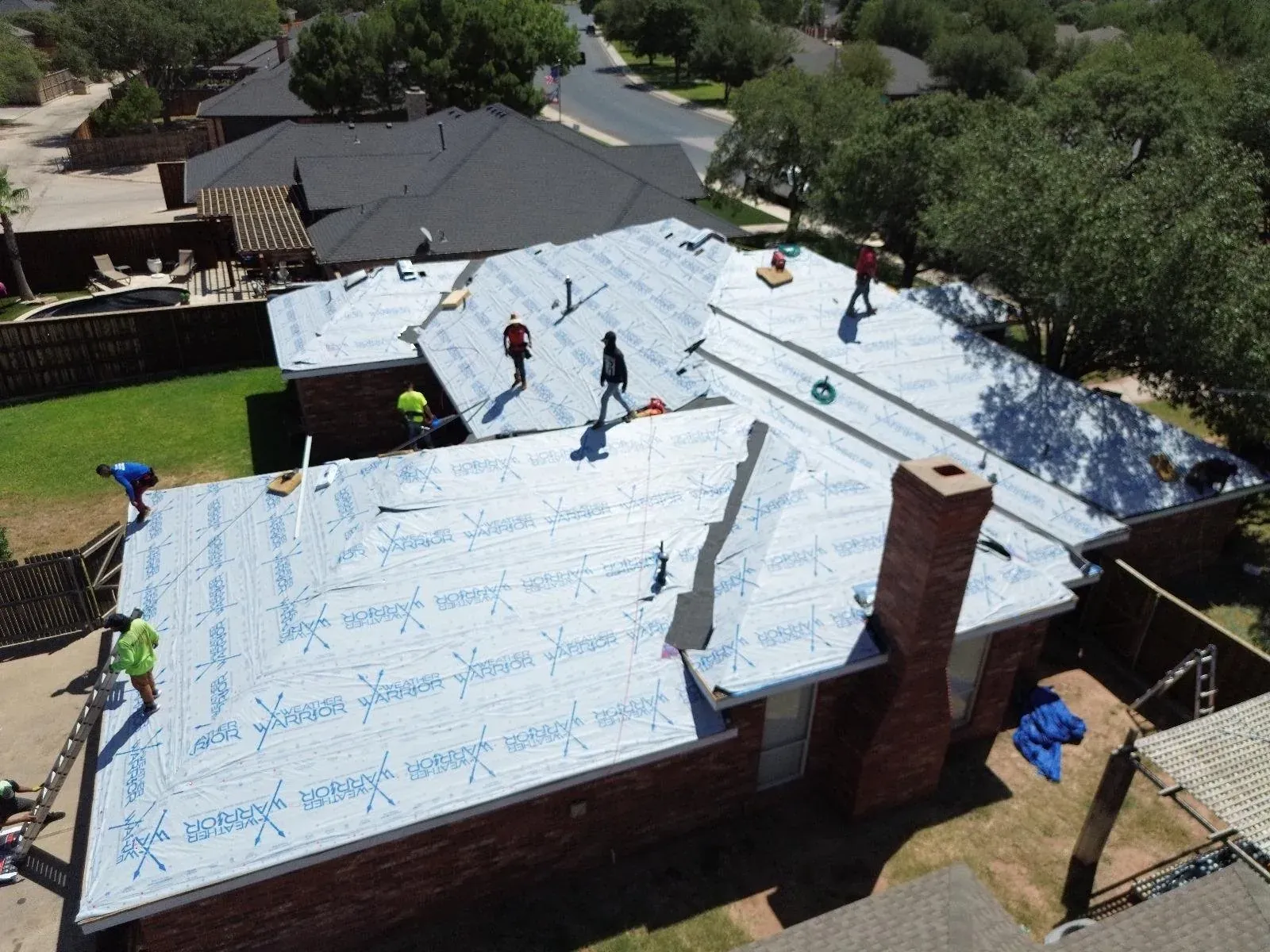 Aerial view of roof underlayment during replacement work