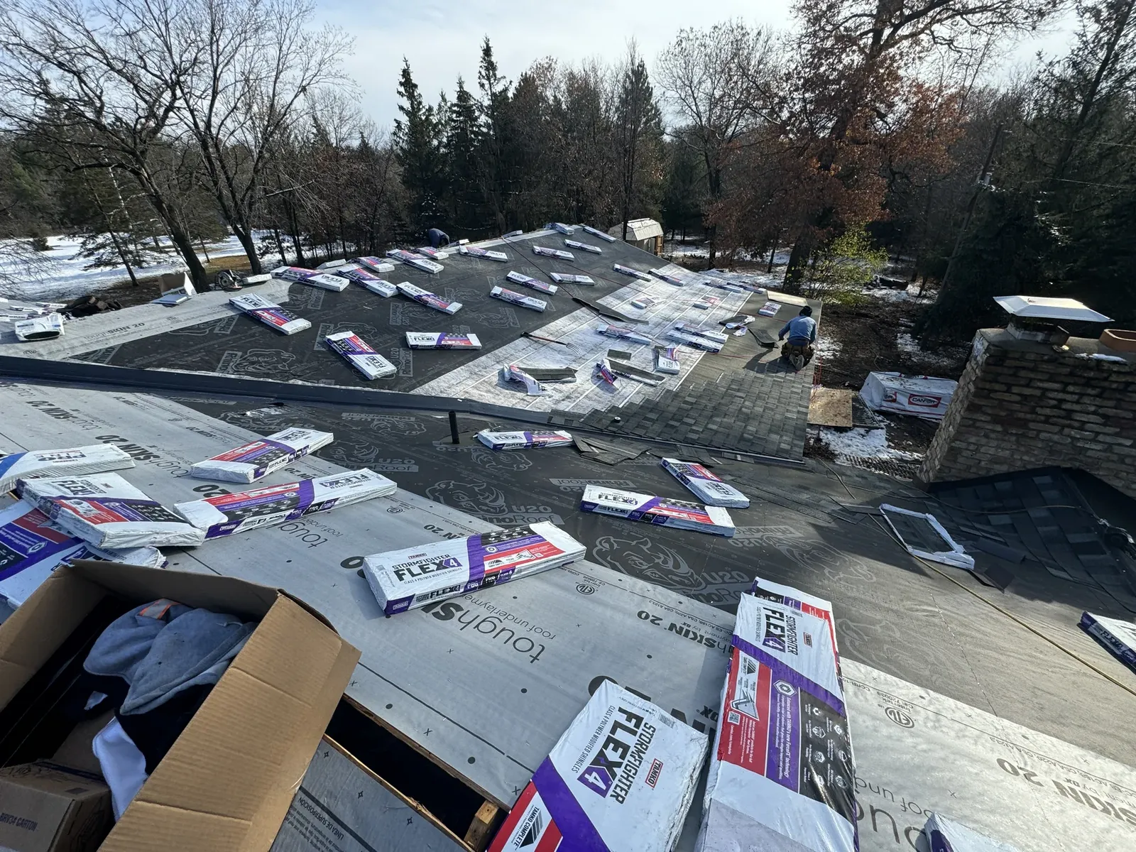 Roofing materials arranged across a roof during replacement work